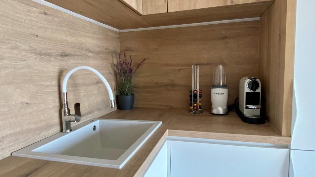 a kitchen with a white sink in a kitchen at Up&Above ,New Luxury Apt, Steps from Beach and Old Town in Hvar