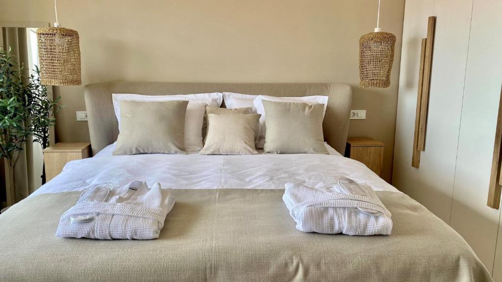 a bedroom with a bed with two towels on it at Up&Above ,New Luxury Apt, Steps from Beach and Old Town in Hvar