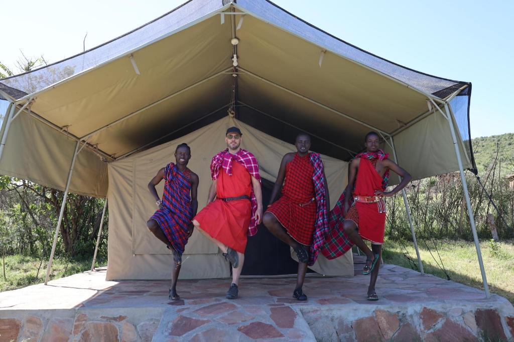 a group of people standing in a tent at Leruk Maasai Mara Camp in Sekenani
