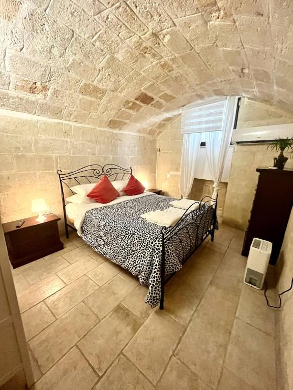 a bedroom with a bed in a stone wall at Perla Marina in Monopoli