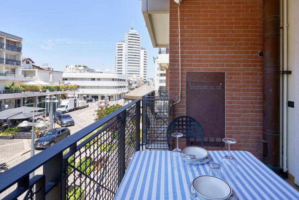 a blue table on a balcony with a view of a city at APPARTAMENTO MARCONI B2 in Lido di Jesolo
