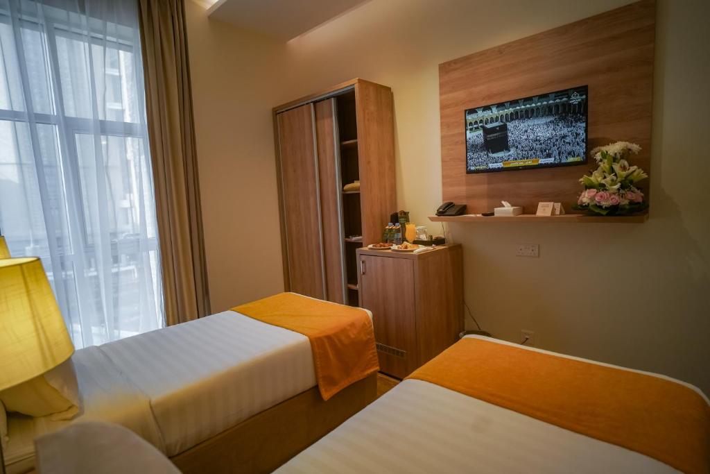 Postel nebo postele na pokoji v ubytování Worth Elite Hotel