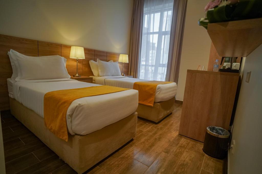 Postel nebo postele na pokoji v ubytování Worth Elite Hotel