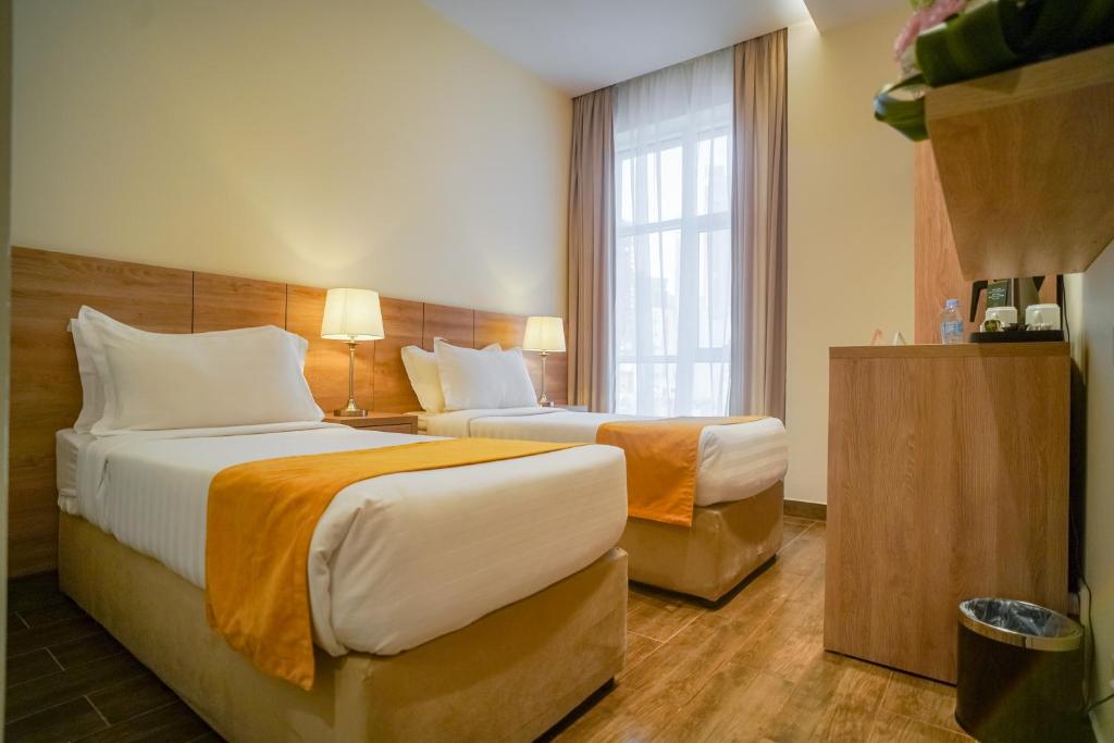 Postel nebo postele na pokoji v ubytování Worth Elite Hotel