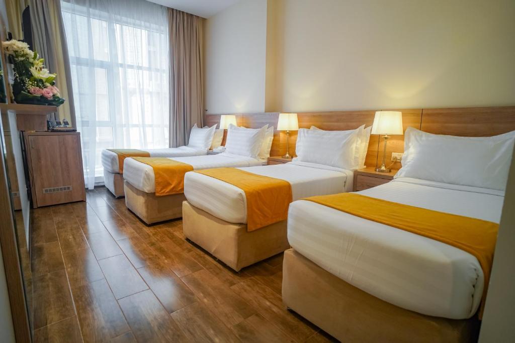 Postel nebo postele na pokoji v ubytování Worth Elite Hotel