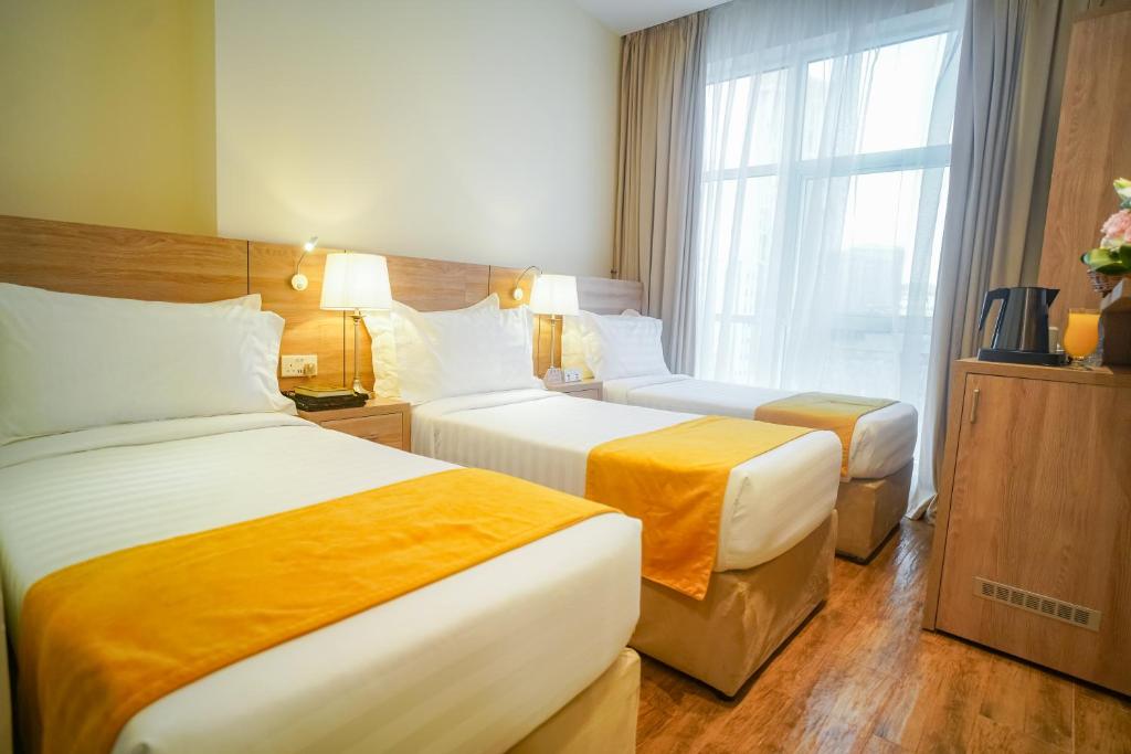 Postel nebo postele na pokoji v ubytování Worth Elite Hotel