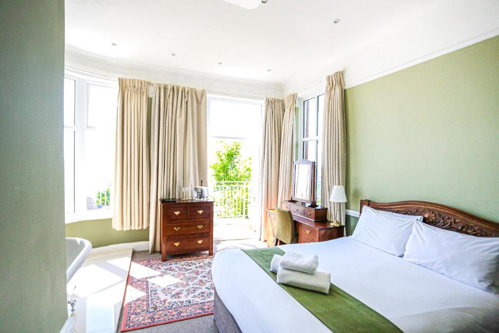 a bedroom with a bed and a window at The Wellington Hotel in Ventnor