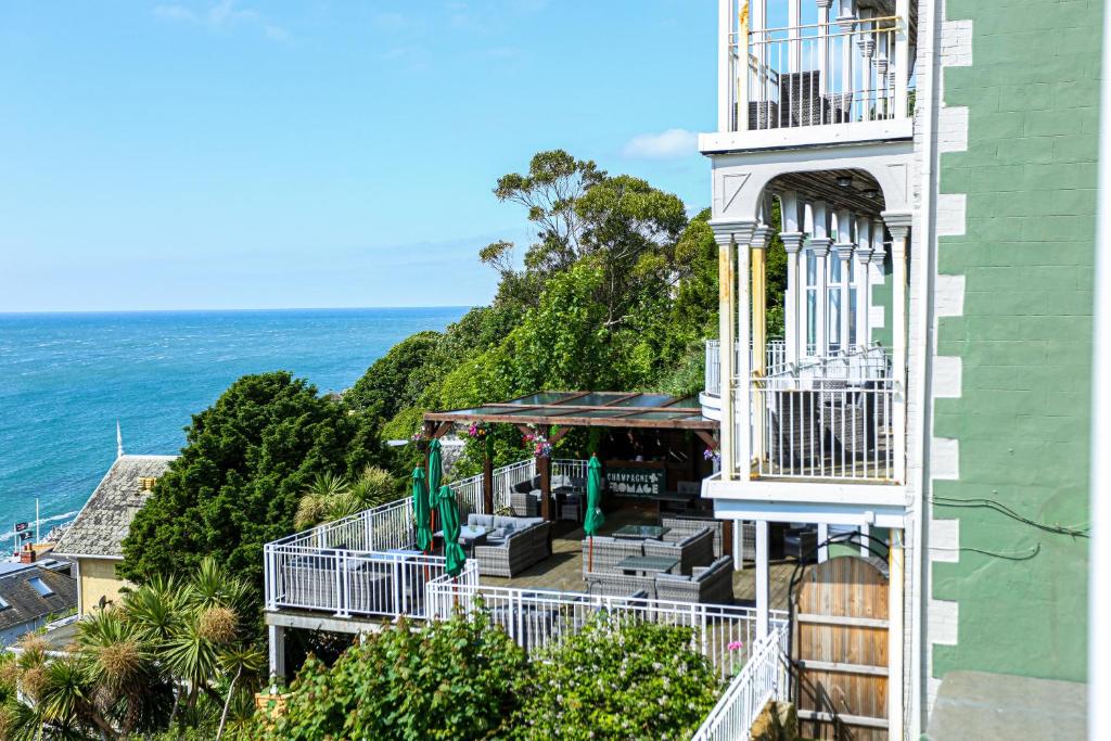 a building with a balcony and the ocean in the background at The Wellington Hotel in Ventnor