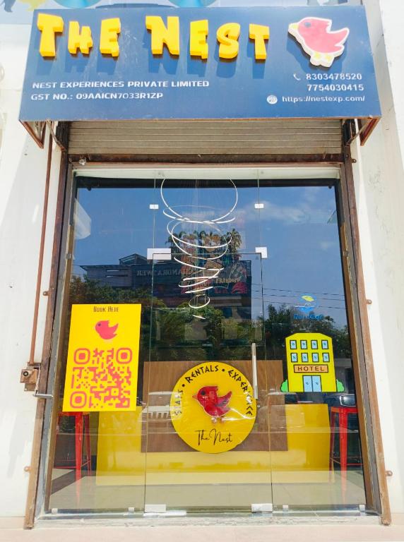 a store window with signs in the window at The Nest Lucknow in Lucknow