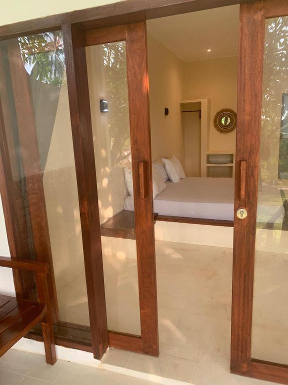 Postel nebo postele na pokoji v ubytování Lombok Coconut Hotel