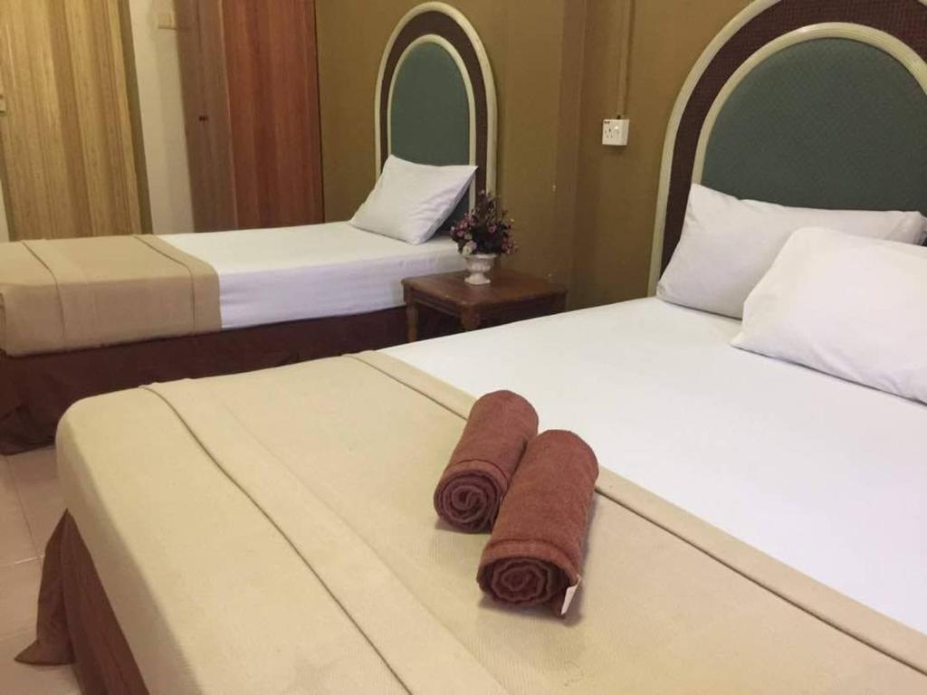 Postel nebo postele na pokoji v ubytování Kemunting Beach Resorts