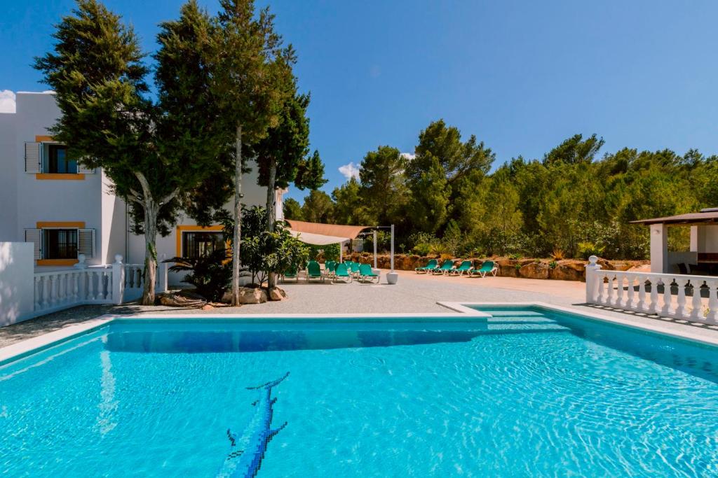 a swimming pool in a villa with a resort at Villa Can Vincent in Sant Josep de Sa Talaia
