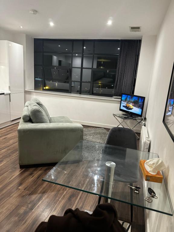 a living room with a couch and a glass table at 533 Luxury Double Studio Apartment Sleeps Two in Birmingham