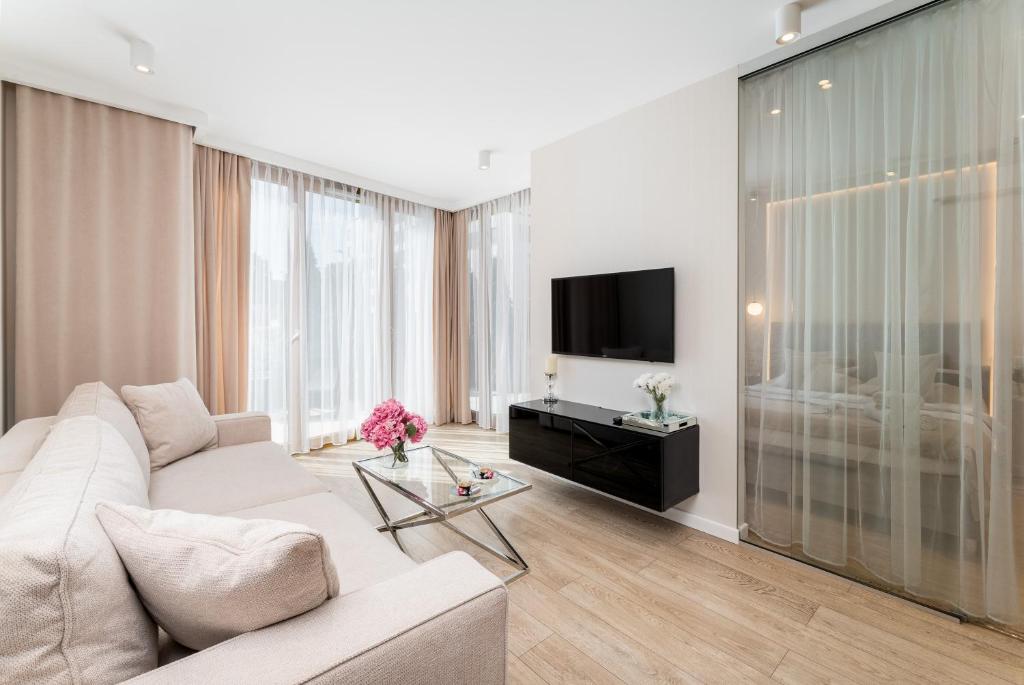 Televízia a/alebo spoločenská miestnosť v ubytovaní Ga Luxury Apartments M54