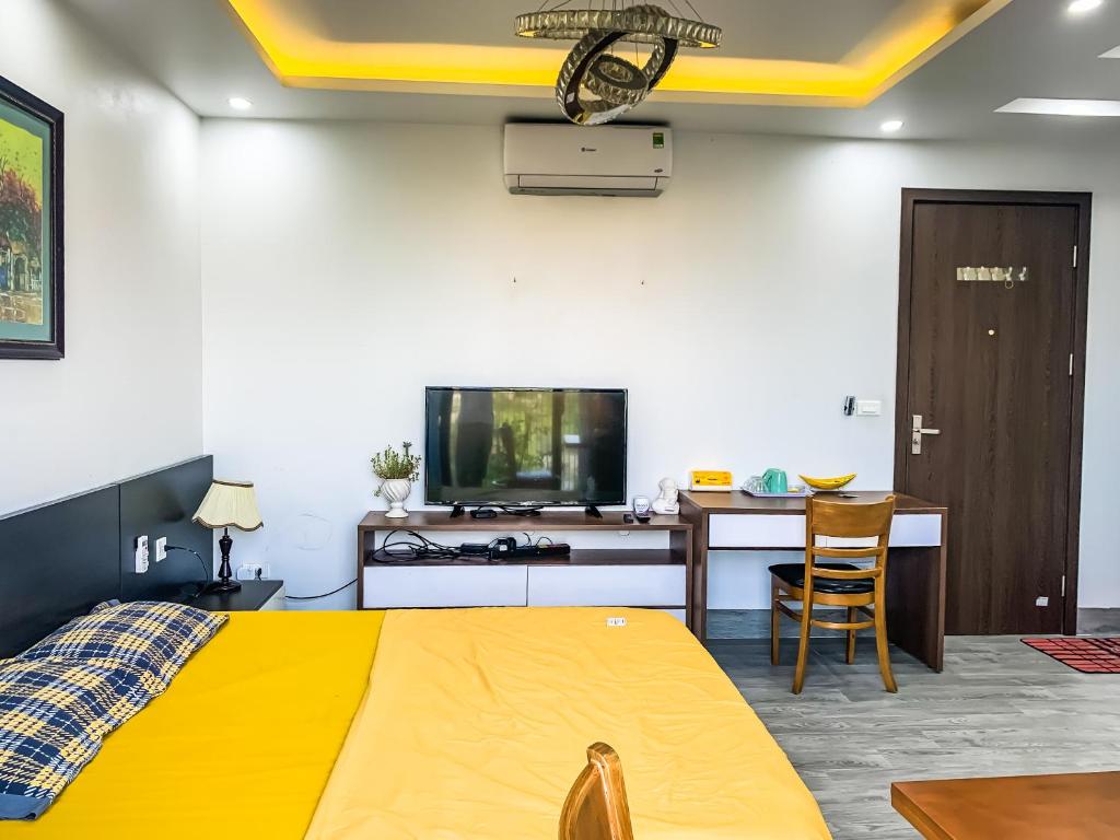 a bedroom with a bed and a desk and a tv at Green Line Long Bien - Serviced Apartment - Ngoc Thuy - Hanoi in Hanoi