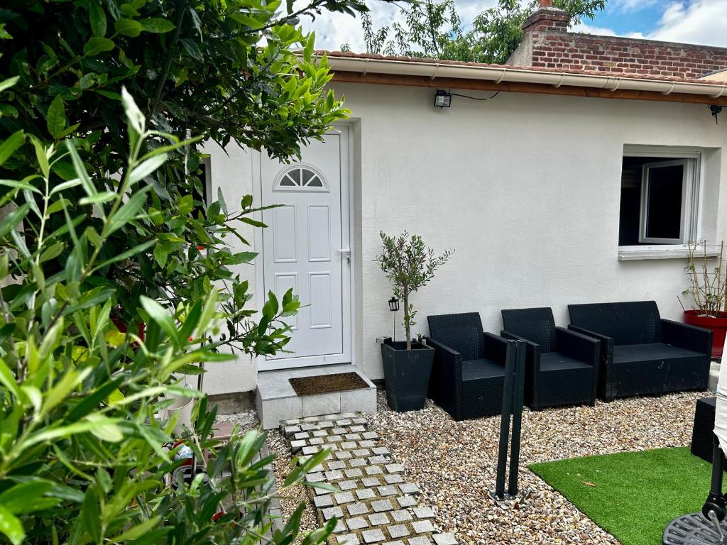 a patio with black furniture in front of a house at Casa Enna in Rueil-Malmaison
