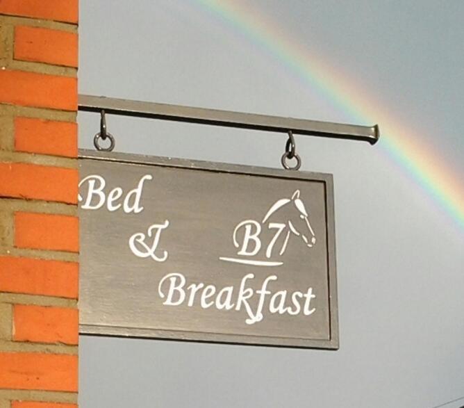 a sign with a rainbow next to a building at B7 Selfkant in Selfkant