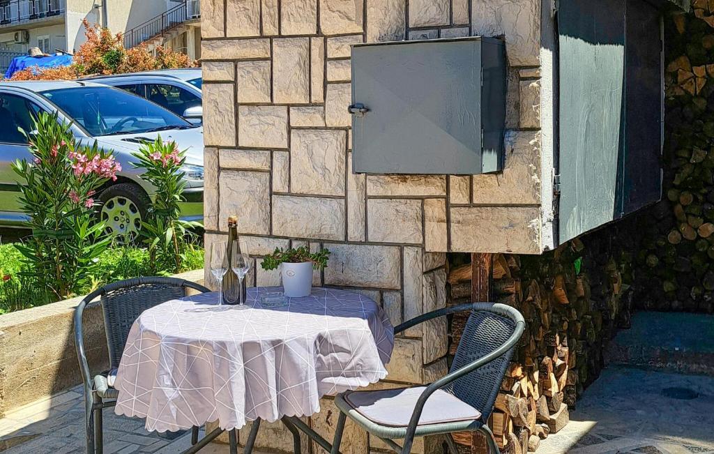 a table and two chairs with a table and a box at Holiday Home Podgorska V in Senj