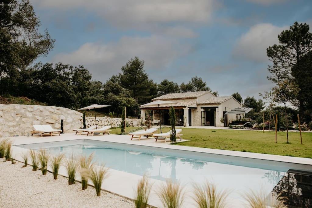 a swimming pool in front of a house at Villa le Mazet de Félicie in Eygalières