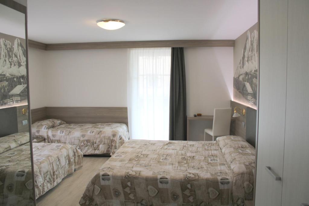 Postel nebo postele na pokoji v ubytování Hotel Villa Cima Undici
