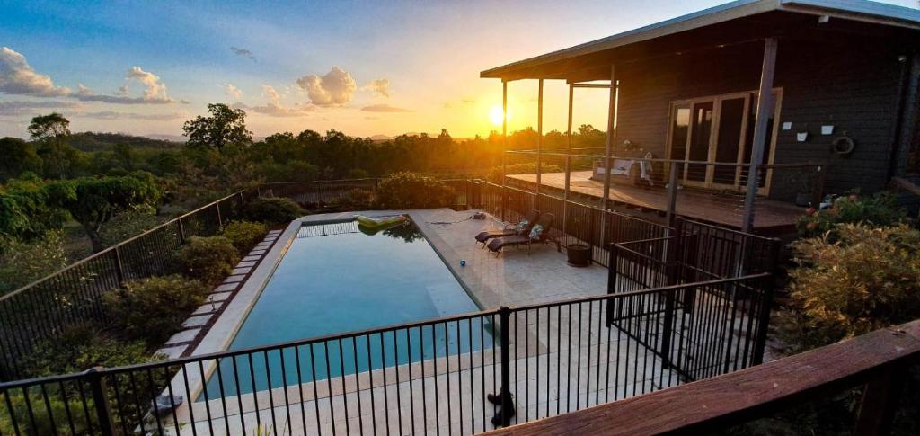 a house with a swimming pool on a balcony at Birds Heaven Mareeba in Mareeba