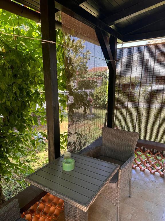 a table and chairs on a screened in porch at Jasna in Poreč