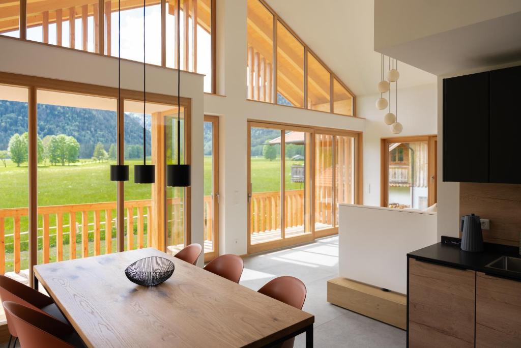 a kitchen and dining room with a table and chairs at Bergblick Chalet in Bayrischzell