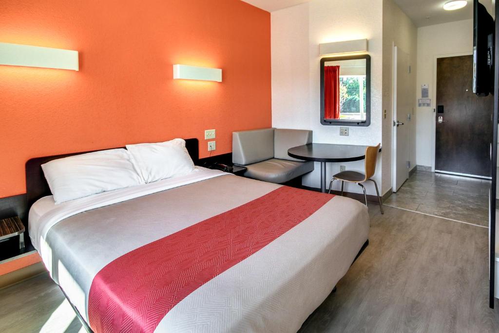 a hotel room with a large bed and a table at Motel 6-Allentown, PA in Allentown
