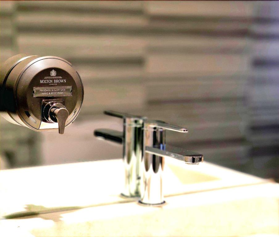 a close up of a bathroom sink with a faucet at The Ciao Stelio Deluxe Boutique Hotel - Adults Only in Larnaka