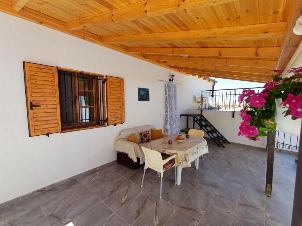 a living room with a table and a couch at Cozy Apartment in Drymades Village in Dhërmi