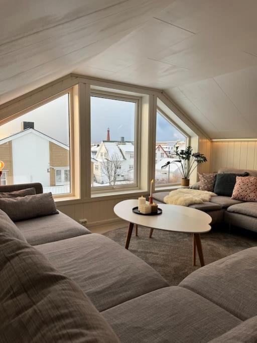 a living room with two couches and a table at Agaton Apartment in Andenes