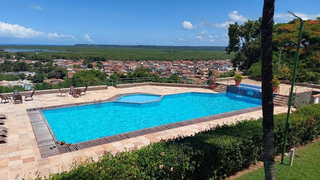 a swimming pool with a view of a city at Jo's Casa 21 in Porto Seguro