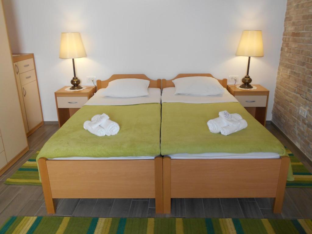 a bedroom with a bed with towels on it at Apartment Ana in Zadar