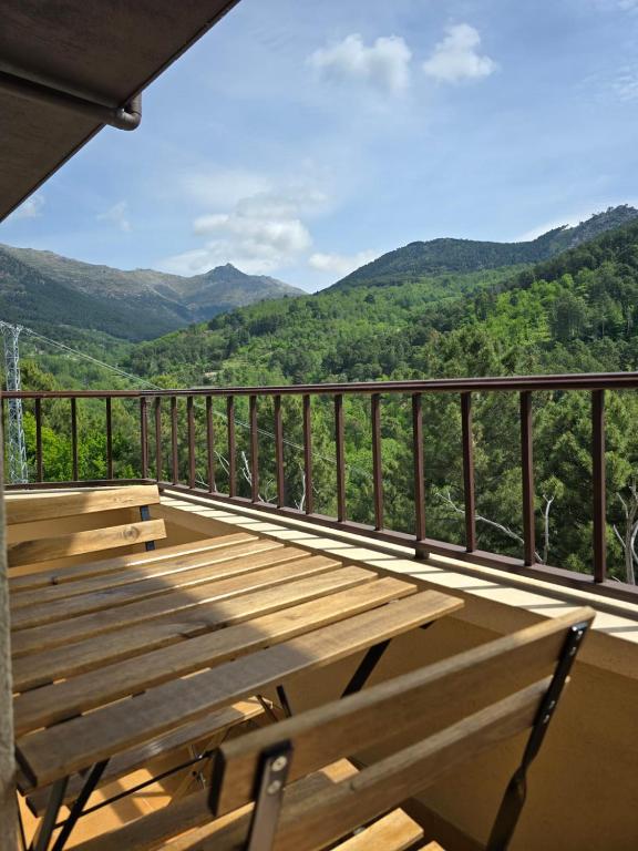 a wooden deck with a view of the mountains at ALBAREÍLLA by #cherrygredos in El Arenal