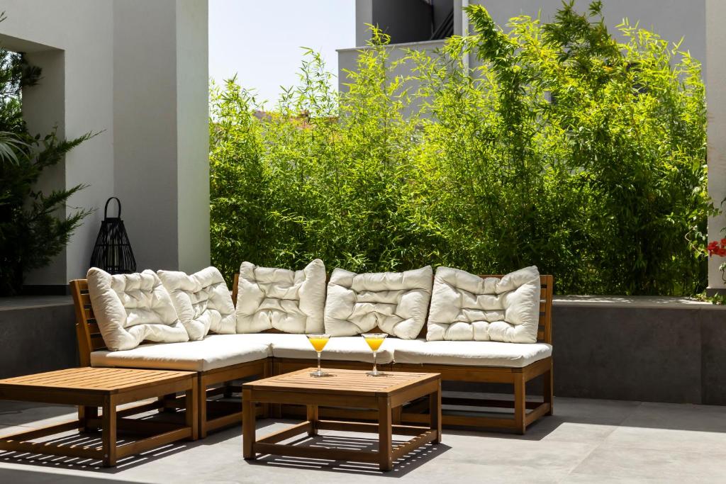 a couch sitting on a patio with two tables at Zen House in Zadar