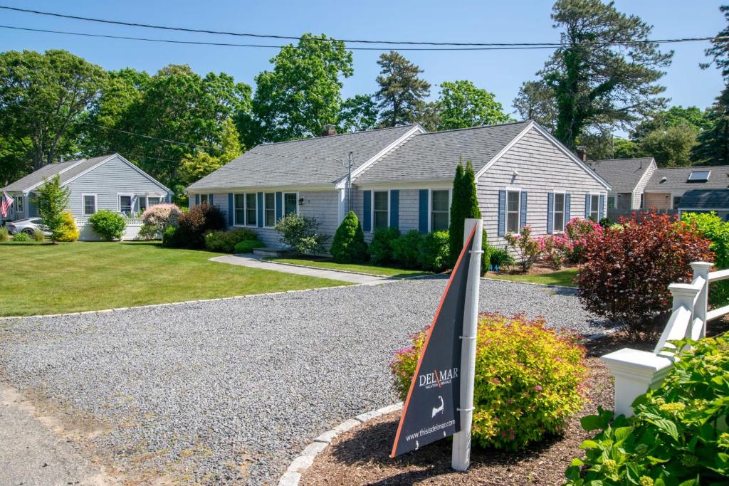 a house with a sign in the driveway at Walk to Earle Rd Beach Incredible Patio in Harwich