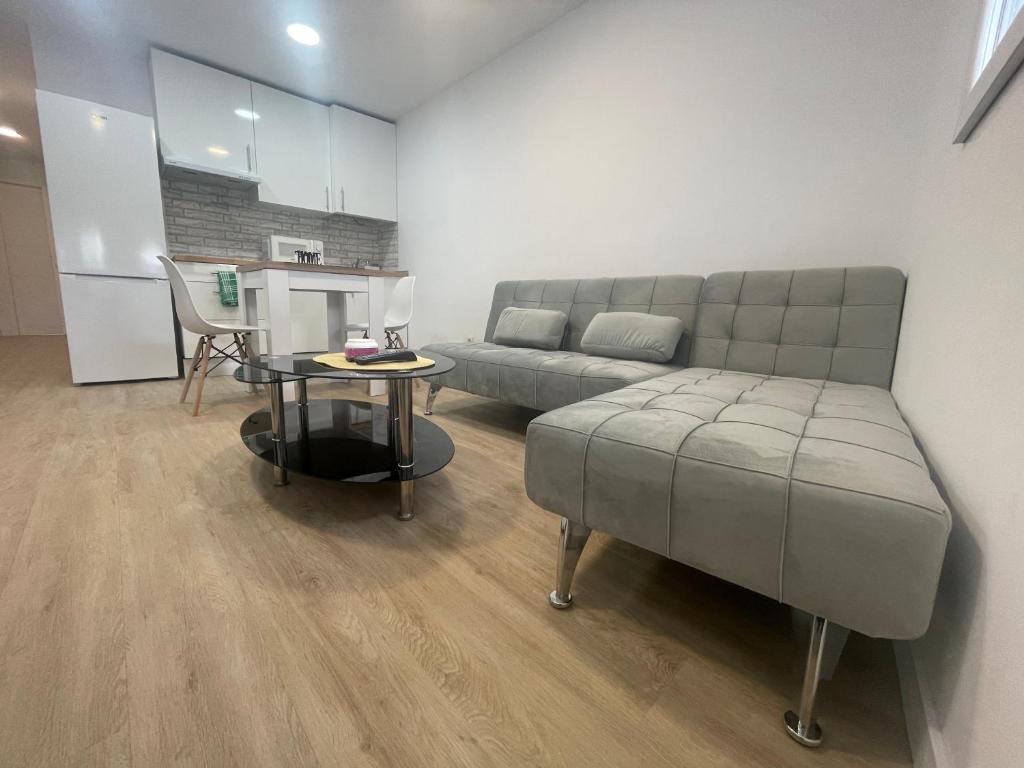 a living room with a couch and a table at Céntrico apartamento muralla 2 in Lugo