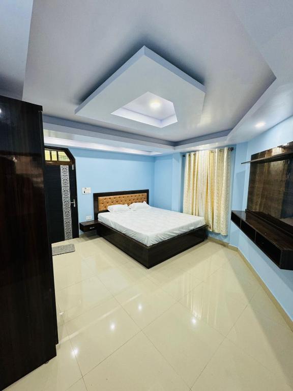a bedroom with a bed in a blue room at Hill inn homestay in Sukhia Pokhari