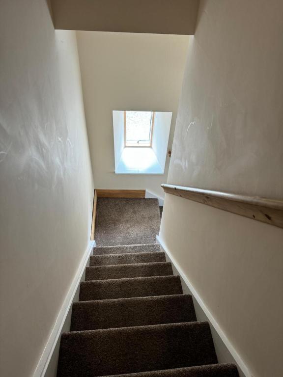 a stairway with a window on the top of it at Dovecot in Altarnun