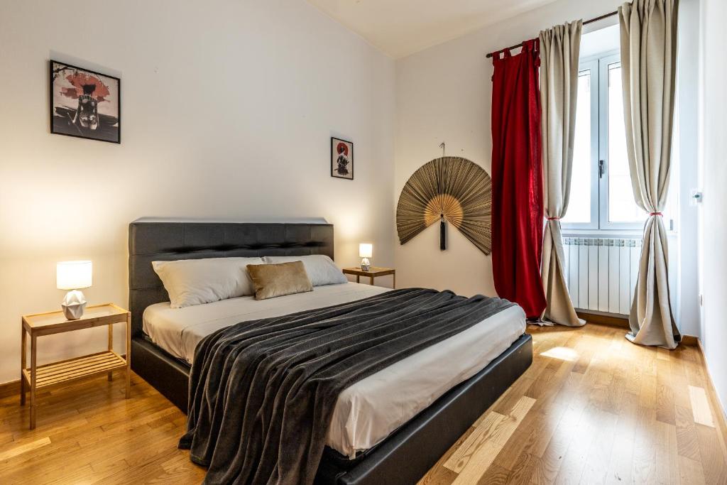 a bedroom with a large bed with red curtains at I_Like_Sassari Apartment2.0 in Sassari