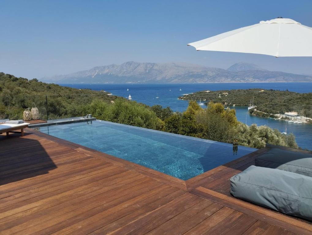 a swimming pool on a deck with a view of the water at Costa Meganisi in Meganisi