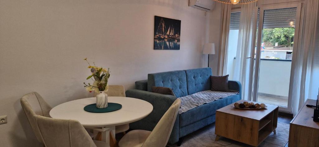 a living room with a blue couch and a table at Zira2 in Kotor