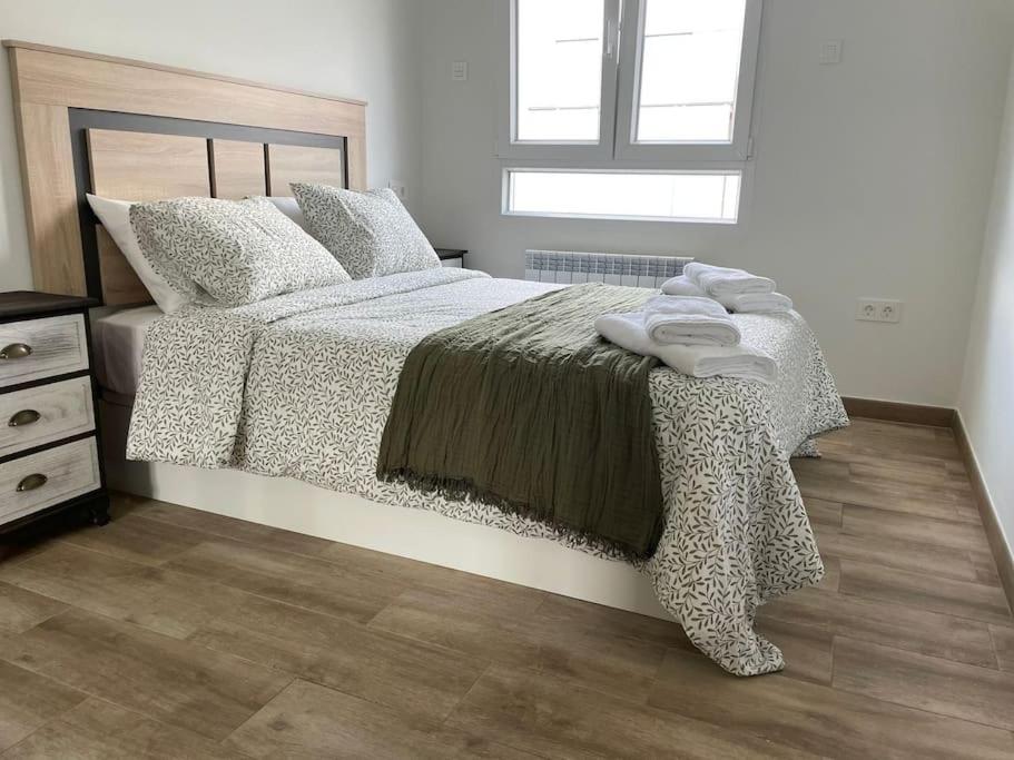 a bedroom with a large bed and a window at Adoracte 4 Mieres Apartamentos in Mieres