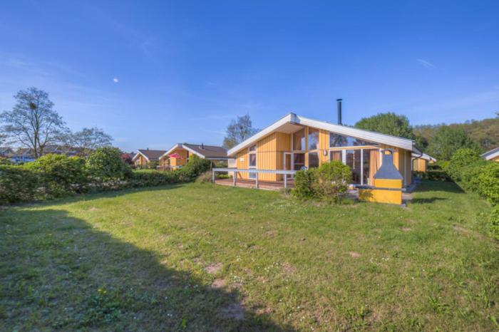 a house with a yard in front of a house at Seeschwalbe 54 in Rechlin