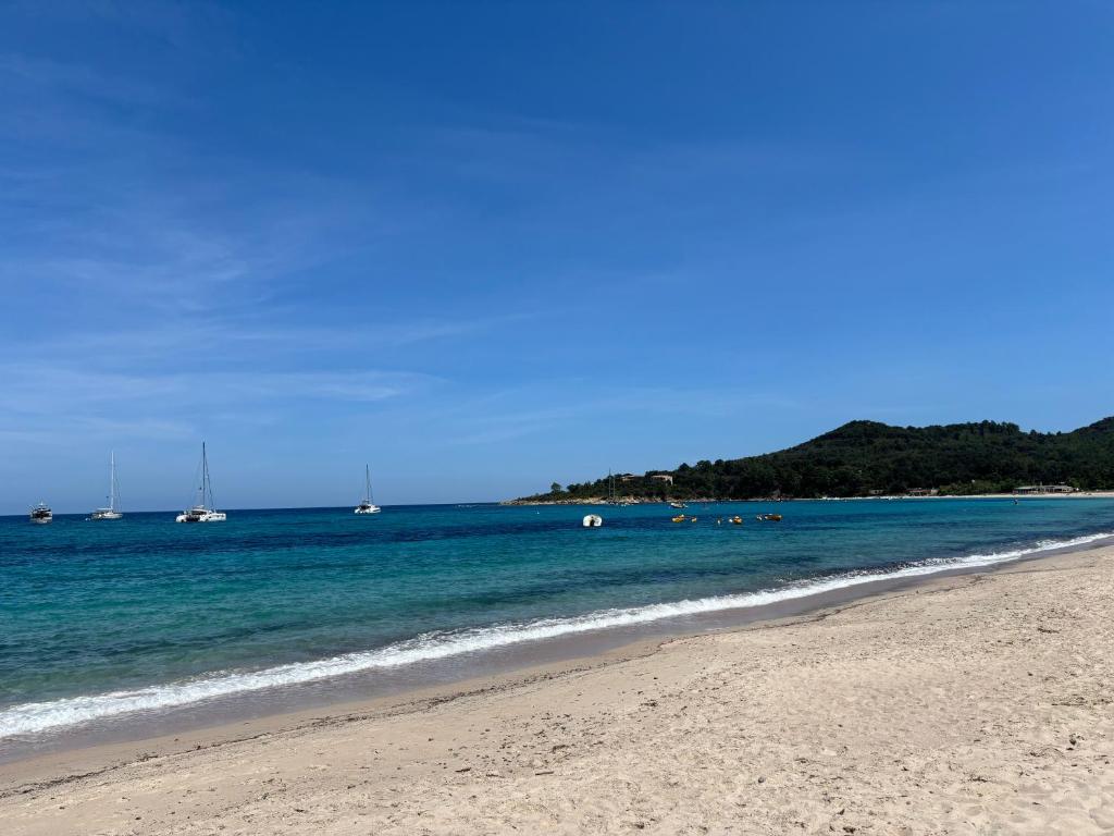 a sandy beach with boats in the water at Villa Casa Sole e Mare in Conca