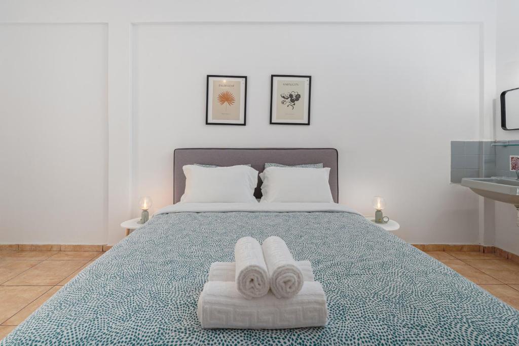 a bedroom with a bed with two towels on it at Eirini Residence in Athens