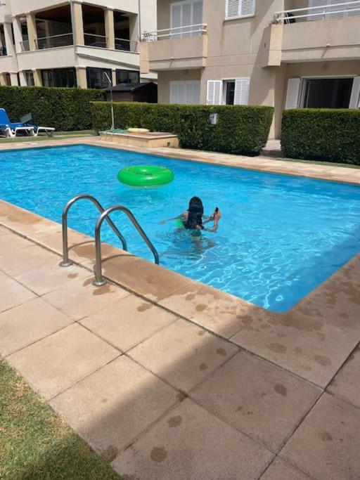 a person in a swimming pool with a frisbee at Family-friendly Beach Escape- 130m2 of pure joy in Port de Pollensa