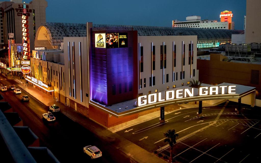 
a large building with a neon sign on the side of it at Golden Gate Casino Hotel in Las Vegas
