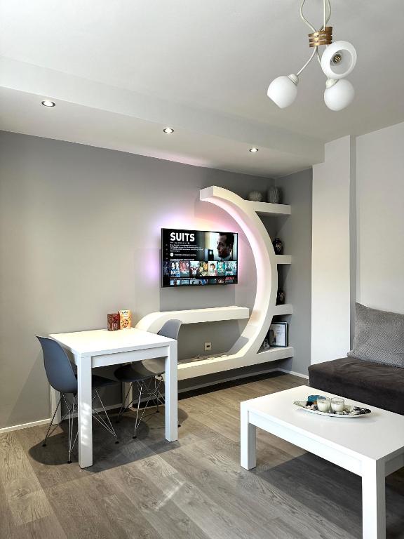 a living room with a tv on a wall at Athena Apartment in Argostoli
