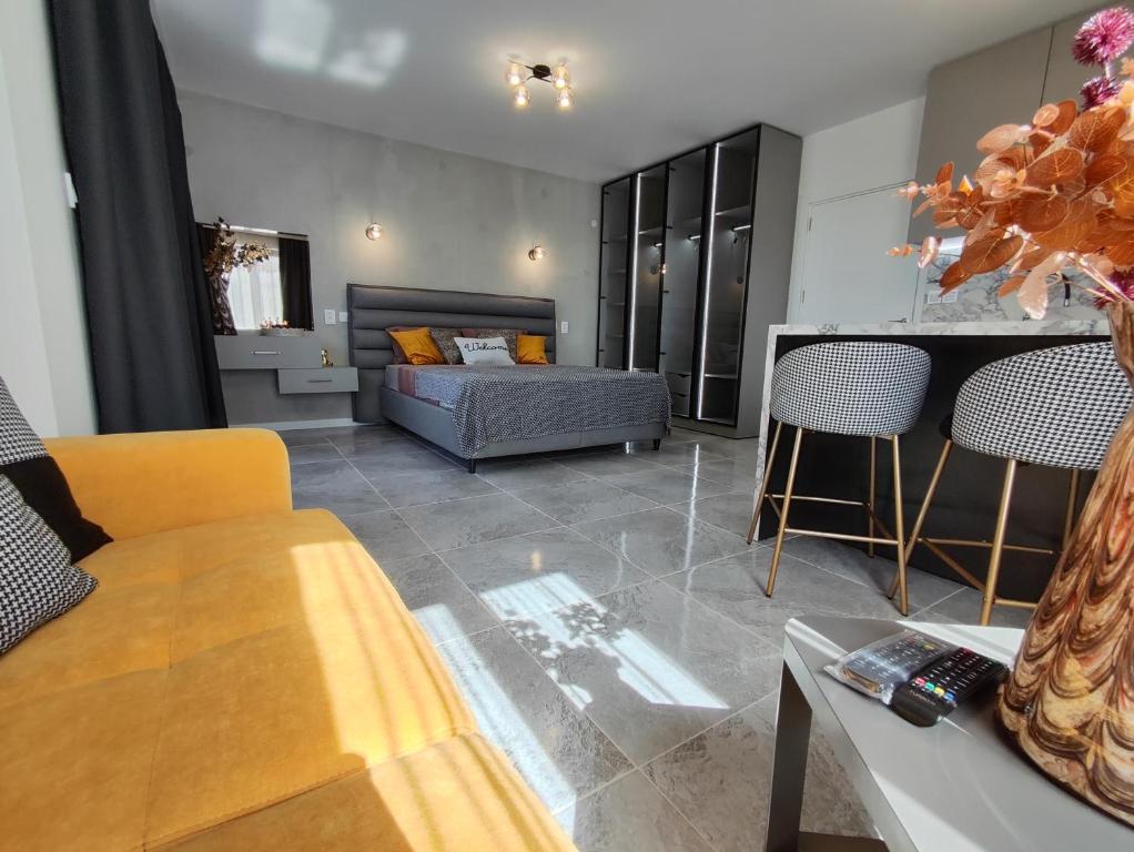 a living room with a couch and a table at студио Водолей in Obzor